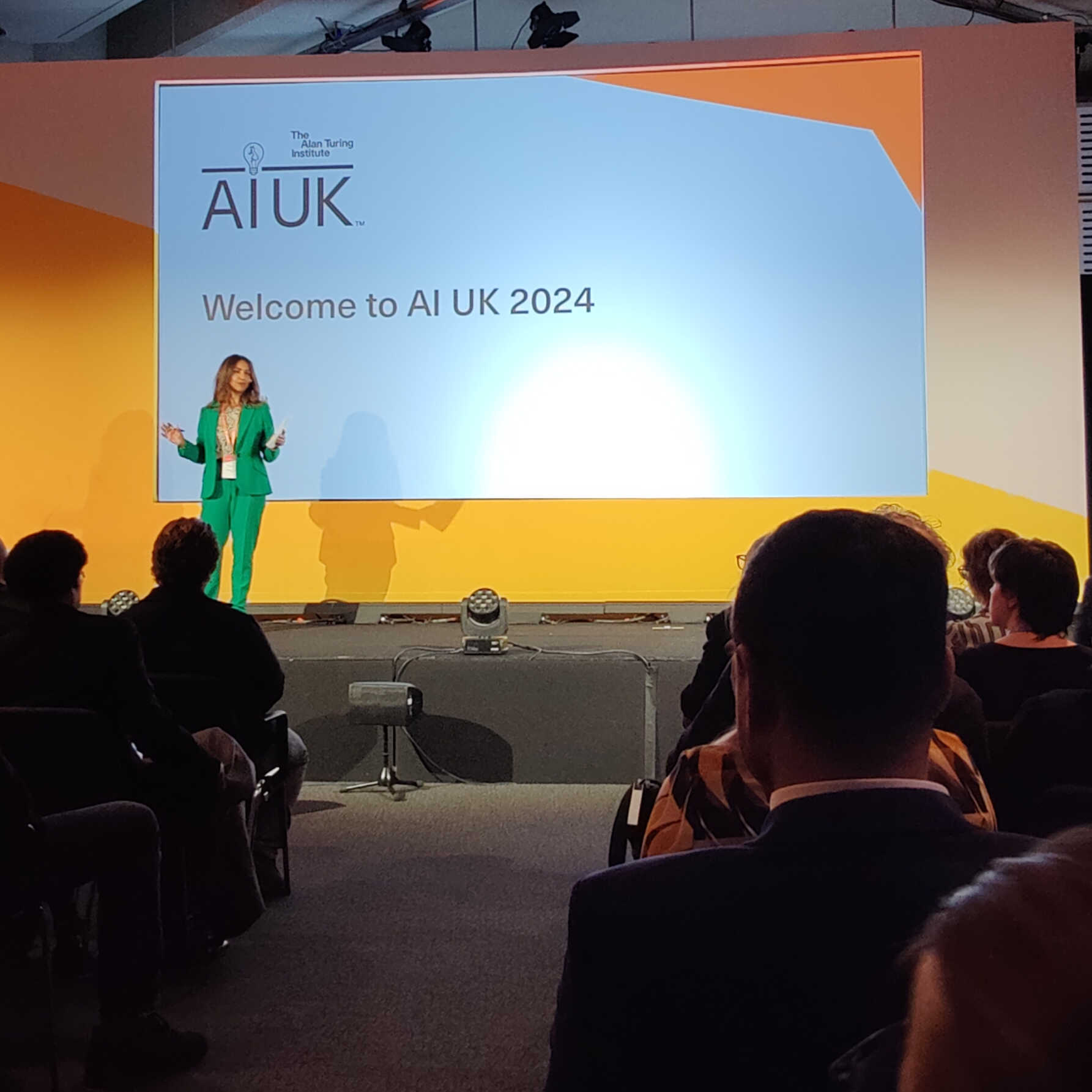 Photo of a speaker on stage at the AI UK 2024 event