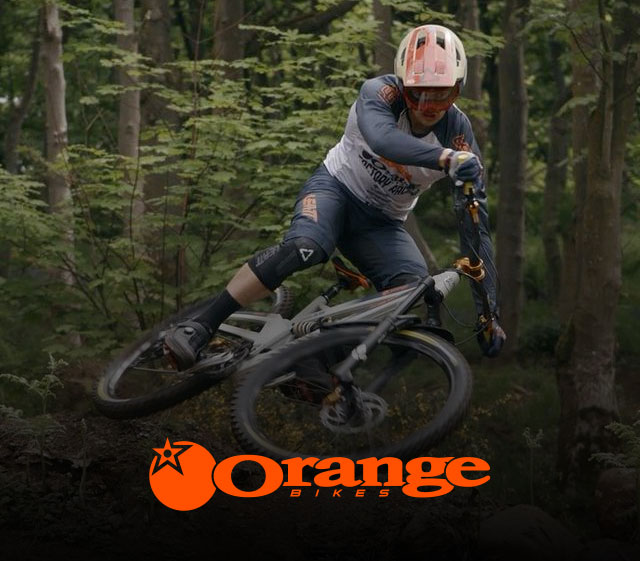 Photo of a mountain bike beingf ridden in a forest