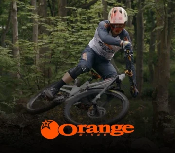 Photo of a mountain bike beingf ridden in a forest