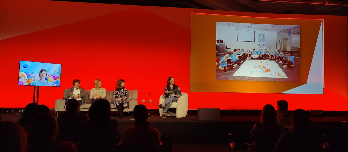 Photo of people on stage discussing children and AI