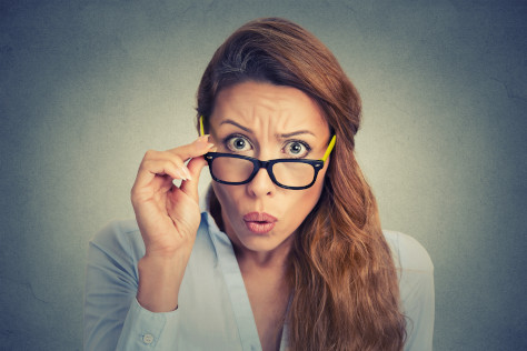 Photo of a woman wearing glasses looking surprised